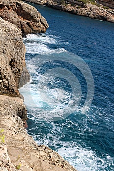 Top view of the stone beach and the waves beating against it. Majorca