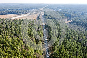 Top view of straight forest roadway. landscape photography with drone on a sunny day