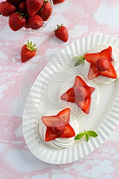 Top view strawberries in meringue nests with mint