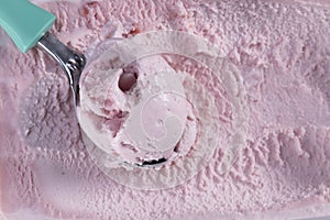 Top view of strawberry flavour ice cream with scoop photo