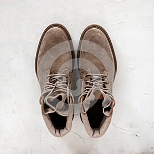 Top view on stylish beige suede boots in beige color. Close-up of elegant men`s seasonal shoes. New trendy spring shoe collection