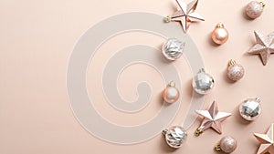 Top view stylish Christmas decorations on ivory background. Flat lay silver and pink Xmas balls and stars. Winter holiday postcard