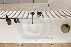 Top view of stylish hotel bathroom interior with sink and accessories on vanity