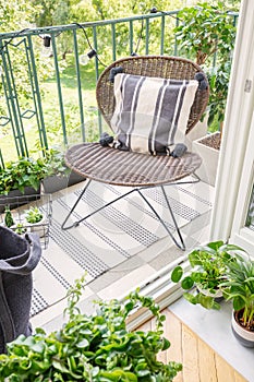 Top view of stylish rattan chair on the balcony of modern flat, real photo