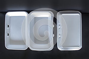 Top view of Styrofoam takeaway boxes, white foam boxes, rectangular shaped clamshell style container with an attached lid, on