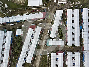 Top view of a subdivision of rowhouses with white sheet metal roofs for low to middle income families. At Naic, Cavite,