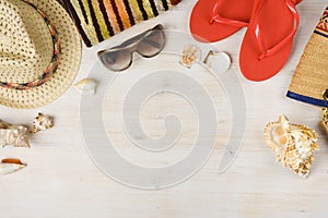 Top view of summer beach accessories on wooden background