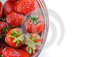 Top view summer fruits. Home strawberry in bowl with water with copy space