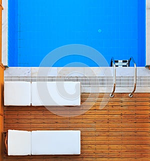 Top view of sunbeds near private pool