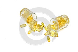 Top view of Supplementary food. Gold fish oil isolated for good health on white background. Omega 3. Vitamin E. Capsules salmon fi