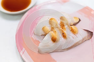 Top view of sushi with white fish, dorado or sea bass, with sauce on top of the fish. Serving on ceramic plate