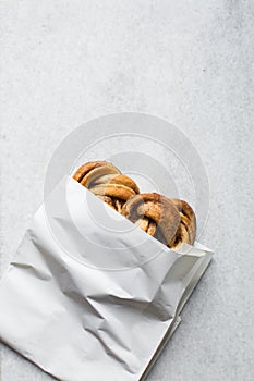 top view of Swedish cinnamon buns in a white bakery bag