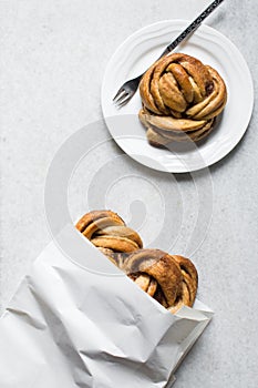 top view of Swedish cinnamon buns in a white bakery bag