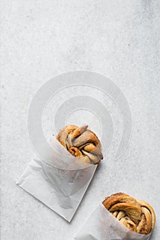 top view of Swedish cinnamon buns in a white bakery bag