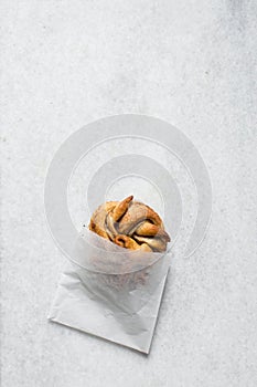 top view of Swedish cinnamon buns in a white bakery bag