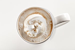 Top view of sweet frappuccino coffee with vanilla ice cream in white ceramic mug. White background. Highest quality of coffee grou