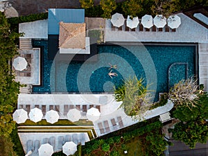 Top view swimming pool, drone view pool, couple in swimming pool during vacation