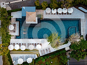 Top view swimming pool, drone view pool, couple in swimming pool during vacation