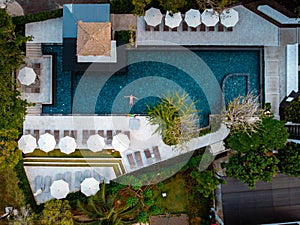 Top view swimming pool, drone view pool, couple in swimming pool during vacation in Thailand