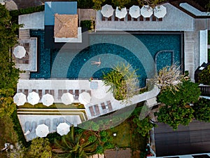 Top view swimming pool, drone view pool, couple in swimming pool during vacation in Thailand