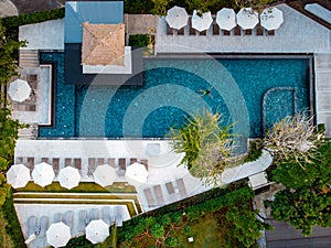 Top view swimming pool, drone view pool, couple in swimming pool during vacation in Thailand