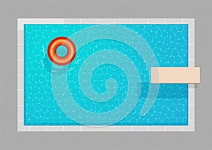 Top view of a swimming pool with rubber ring and diving board