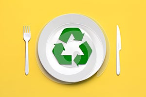 Top view of Symbol of recycling with white plastic cutlery and plate. Eco friendly recycling concept