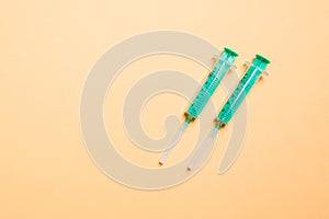 Top view of syringes in a row for medical injection on colorful background with copy space. Health and vaccination concept