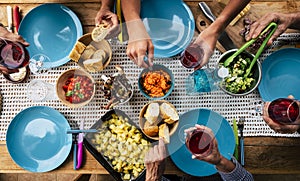 Top view of table full of food and riends enjoying event together - blue dishes and colorful background - concept of no