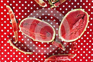 Top view of table and pieces of juicy watermelon, rinds of it. Slices and sections of watermelon