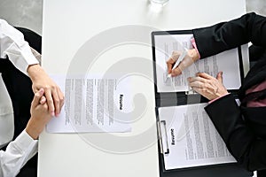 Top view of a table with a senior female HR manager and a candidate in a job interview