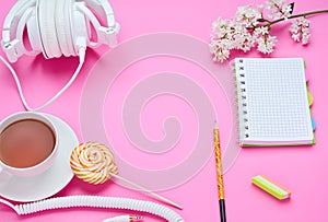 Top view of the table of a teenage child, composition of pencil for laptop eraser flower glass with drink earphone Lollipop on
