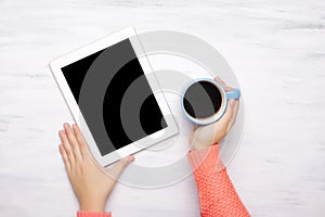 Top view of a tablet gadget on a white wooden table