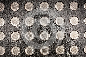 Metal tactile paving tiles for the blind. stainless steel stud of tactile paving. Top view of round protruding pimples placed on