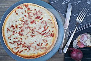 Top view of taditional food `Tarte Flambee` or `Flammkuchen` from German-French Alsace border region