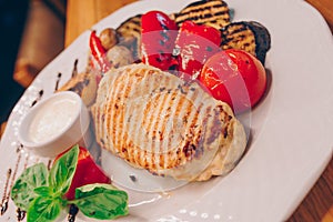 Top view tasty grill vegetarian vegan assorti salad sliced onion pepper with cheese in european style, meal on large rounded white