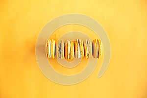 Top view of tasty orange yellow macarons photo