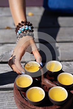 Top view tea set a wooden table for tea ceremony background. Woman and man holding a cup of tea