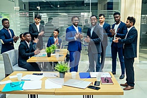 Top view of team work high five a group of successful afro americans, europeans ,arabic and korean businessman and