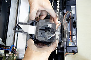 Top view of technician repairing printer