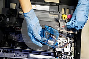 Top view of technician repairing and using printer repair tools