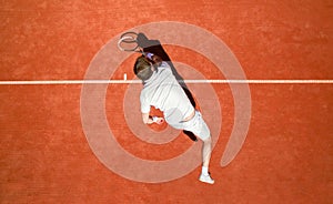 Top view of tennis player hitting ball