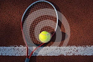 Tennis ball, racquet on hard court surface