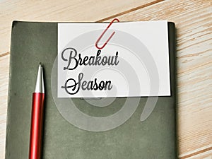Top view text Breakout Season written on white paper note