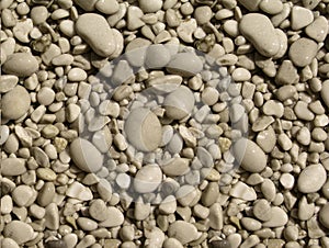 Top view of a textured surface covered with smooth white pebbles