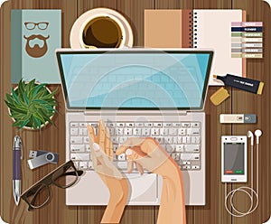 Top view with textured table, computer, laptop, notebook, pen, mobile phone, headset, hands, make, flash drive,
