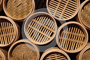 Top view of textured wall with bamboo wood circular steam baskets, Asian culinary theme background