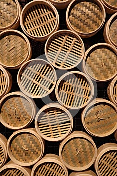 Top view of Textured wall with bamboo wood circular steam baskets, Asian culinary theme background