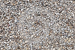 Top view of textured yellow and white pebble stones ground