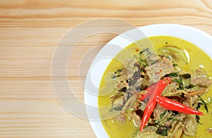 Top View of Thai Green Curry or Kaeng Keaw Wan with Beef Served on Wooden Table